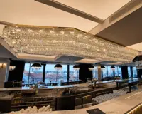 Duży żyrandol kryształowy ze zwisami zainstalowany w luksusowej restauracji z widokiem